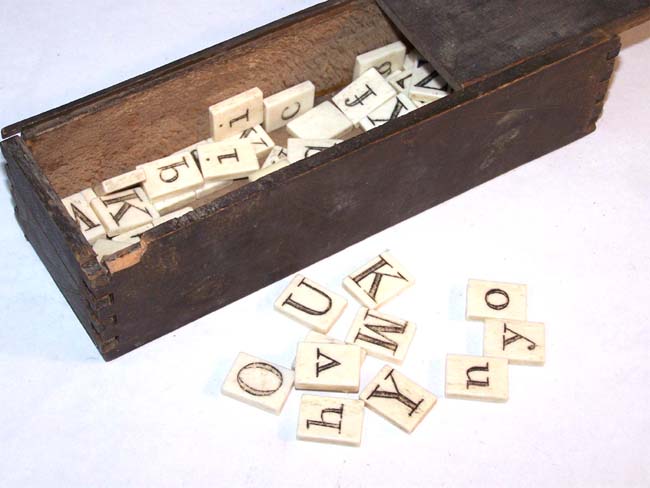 A Boxed set of 19th century Ivory or Bone Alphabets, 63 pieces, circa 1840 — image 2